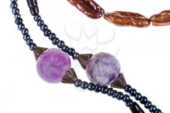 strings of amethyst, ceramic beads of handmade woman necklace isolated on white background