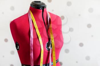 tailors women dummy with two measure tapes