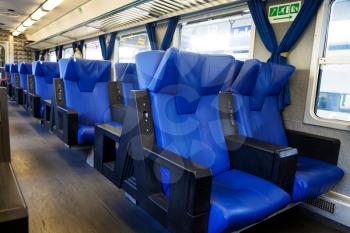 blue seats and interior of suburban train wagon
