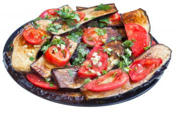 fried eggplants with red tomato and garlic on black plate isolated with white background
