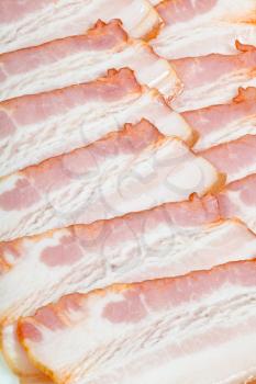 sliced pieces of bacon on plate close up