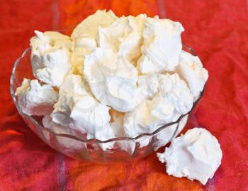 meringue sweet dessert from whipped egg whites and sugar in glass bowl
