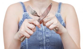 crossing fork and table knife in female hands