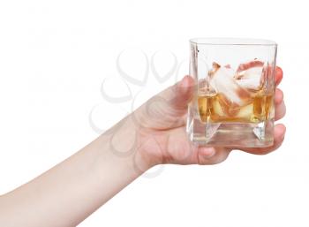 hand holds glass with whiskey isolated on white background