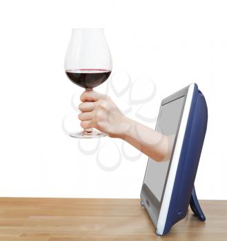 hand raising big glass with red wine leans out TV screen isolated on white background
