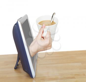 hand holding cup of coffee with milk leans out TV screen isolated on white background