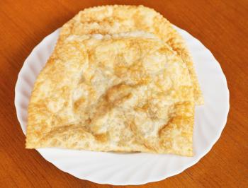 Crimean tatar cuisine - top view of chiburekki pie on white plate