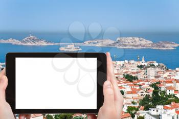 travel concept - tourist photograph skyline Marseille city, Franceon tablet pc with cut out screen with blank place for advertising logo