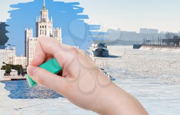 season concept - hand deletes frozen Moskva river by rubber eraser from image and Moscow summer cityscape are appearing