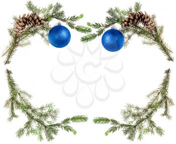 christmas greeting card frame - green tree branches with cones and blue balls on white background