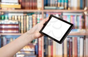 hand holds tablet pc with cut out screen in library