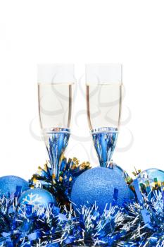 two glasses of champagne at blue Xmas decorations close up isolated on white background