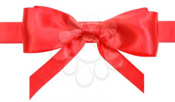 real red satin bow with vertically cut ends on ribbon close up isolated on white background