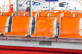 empty orange seat in departure area of airport