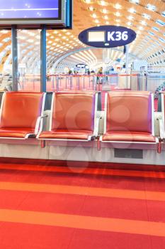 empty red seat in departure hall of airport
