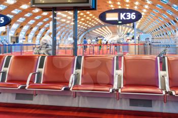 empty red seat in departure lounge of airport