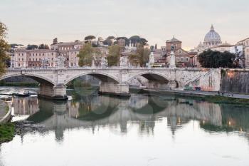 travel to Italy - Rome city skyline with Tiber River, and bridge Ponte Vittorio Emanuele II, dome of Saint Peter Basilica in Vatican in evening twilight