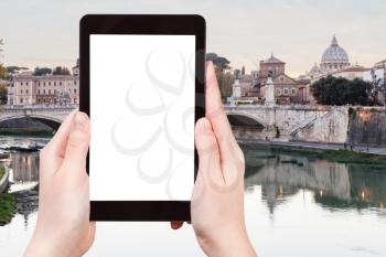travel concept - tourist photographs Rome city in evening on tablet with cut out screen with blank place for advertising in Italy
