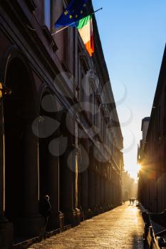 travel to Italy - sun beams illuminate Via Zamboni in University district of Bologna city in autumn