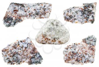 collection of raw and tumbled calcite stones with brown chondrodite and green diopside crystals isolated on white background