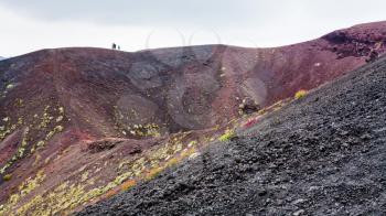 travel to Italy - people on edge of crater on Mount Etna in Sicily in summer day