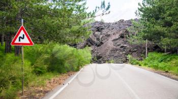 travel to Italy - hardened lava flow broken road on slope of Etna volcano in Sicily