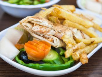 Travel to Middle East country Kingdom of Jordan - typical arabian fast food Shawerma with chicken meat in outdoor cafe in Aqaba city