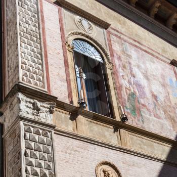 travel to Italy - wall with fresco on medieval palazzo thiene on street contra porti in Vicenza city in spring.