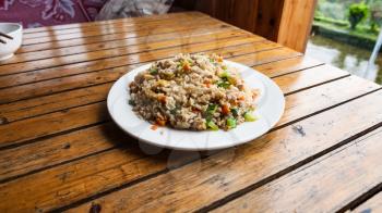 travel to China - plate with fried rice with vegetables in rustic eatery in area Dazhai Longsheng Rice Terraces (Dragon's Backbone terrace, Longji Rice Terraces) country in spring