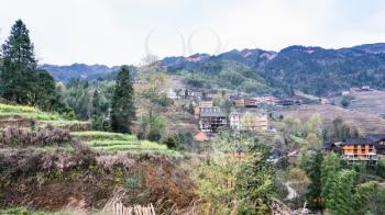 travel to China - view of Tiantouzhai village in terraced hills from viewpoint Seven Stars Chase The Moon in Dazhai Longsheng Rice Terraces (Dragon's Backbone terrace, Longji Rice Terraces) country