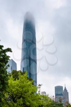GUANGZHOU, CHINA - MARCH 31, 2017: clouds over skyscraper in Zhujiang New Town of Guangzhou city in rainy day. Guangzhou is the third most-populous city in China with population about 13,5 mln