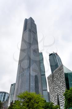 GUANGZHOU, CHINA - MARCH 31, 2017: glass towers in Zhujiang New Town of Guangzhou city in cloudy day. Guangzhou is the third most-populous city in China with population about 13,5 mln