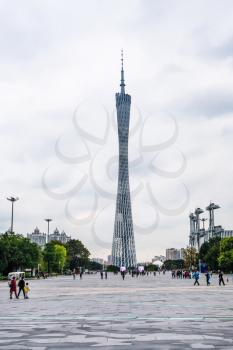 GUANGZHOU, CHINA - MARCH 31, 2017: visitors on square in Zhujiang New Town of Guangzhou city in rainy day and Guangzhou (Canton) TV Astronomical and Sightseeing Tower. The tower was topped out in 2009