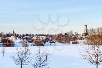 cityscape of Suzdal town with Holy Cross Exaltation and St Cosmas and St Damian Churches in Korovniki district and Prepodobenskay Bell Tower of Deposition of the Robe of Theotokos Convent in winter