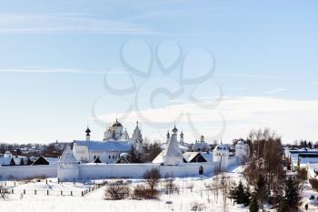 view of Convent of the Intercession (Pokrovskiy Monastery) on riverbank of frozen river in Suzdal town in winter in Vladimir oblast of Russia