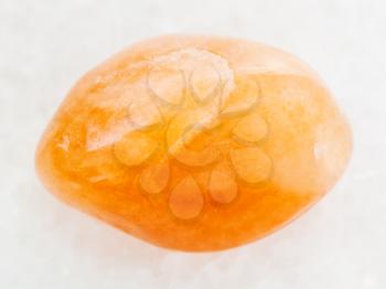 macro shooting of natural mineral rock specimen - polished yellow aventurine gemstone on white marble background from India