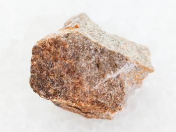 macro shooting of natural mineral rock specimen - raw Quartzite stone on white marble background