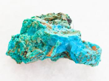 macro shooting of natural mineral rock specimen - Chrysocolla stone in copper sandstone on white marble background from Zabaykalsky Krai of Russia