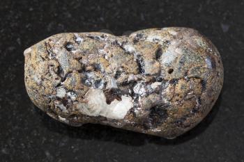 macro shooting of natural mineral rock specimen - pebble of sphalerite stone with Galena on dark granite background from Dalnegorsk region of Primorsky Krai, Russia