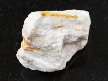 macro shooting of natural mineral rock specimen - raw Baryte ore on dark granite background from Belorechenskoye mine, Adygea, Russia