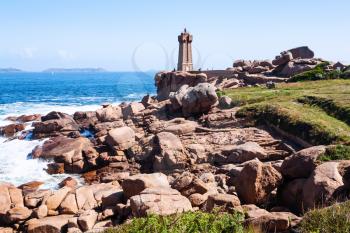 travel to France - Mean Ruz lighthouse in Ploumanac'h site on coast of English Channel in Perros-Guirec commune on Pink Granite Coast of Cotes-d'Armor department of Brittany in sunny summer day