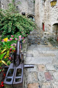 travel to France - decorated lane in historic center of Dinan town in rain