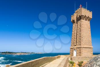 travel to France - edifice of Mean Ruz lighthouse in Ploumanac'h site on English Channe coast in Perros-Guirec commune on Pink Granite Coast of Cotes-d'Armor department of Brittany in sunny day