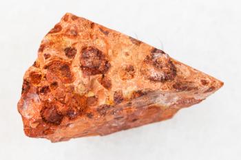 macro shooting of natural mineral rock specimen - rough bauxite ore on white marble background from Ukraine