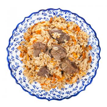 top view of cooked plov(central asian dish from rice with meat and vegetable) on local ceramic plate isolated on white background