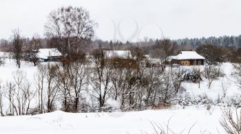 view of old little russian village in overcast winter day in Smolensk region of Russia