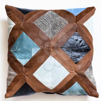 top view of patchwork leather decorative pillow on white background