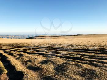 travel to North Caucasus region region - wheel tracks on surface of Bermamyt mountain Plateau at morning