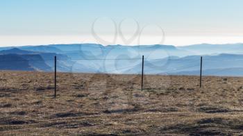 travel to North Caucasus region region - fence of observation deck on top of Bermamyt mountain Plateau in Caucasus Mountains at september morning