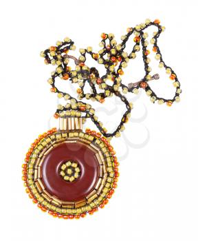 handcrafted necklace with round brown leather pendant decorated by glass beads and bugles isolated on white background
